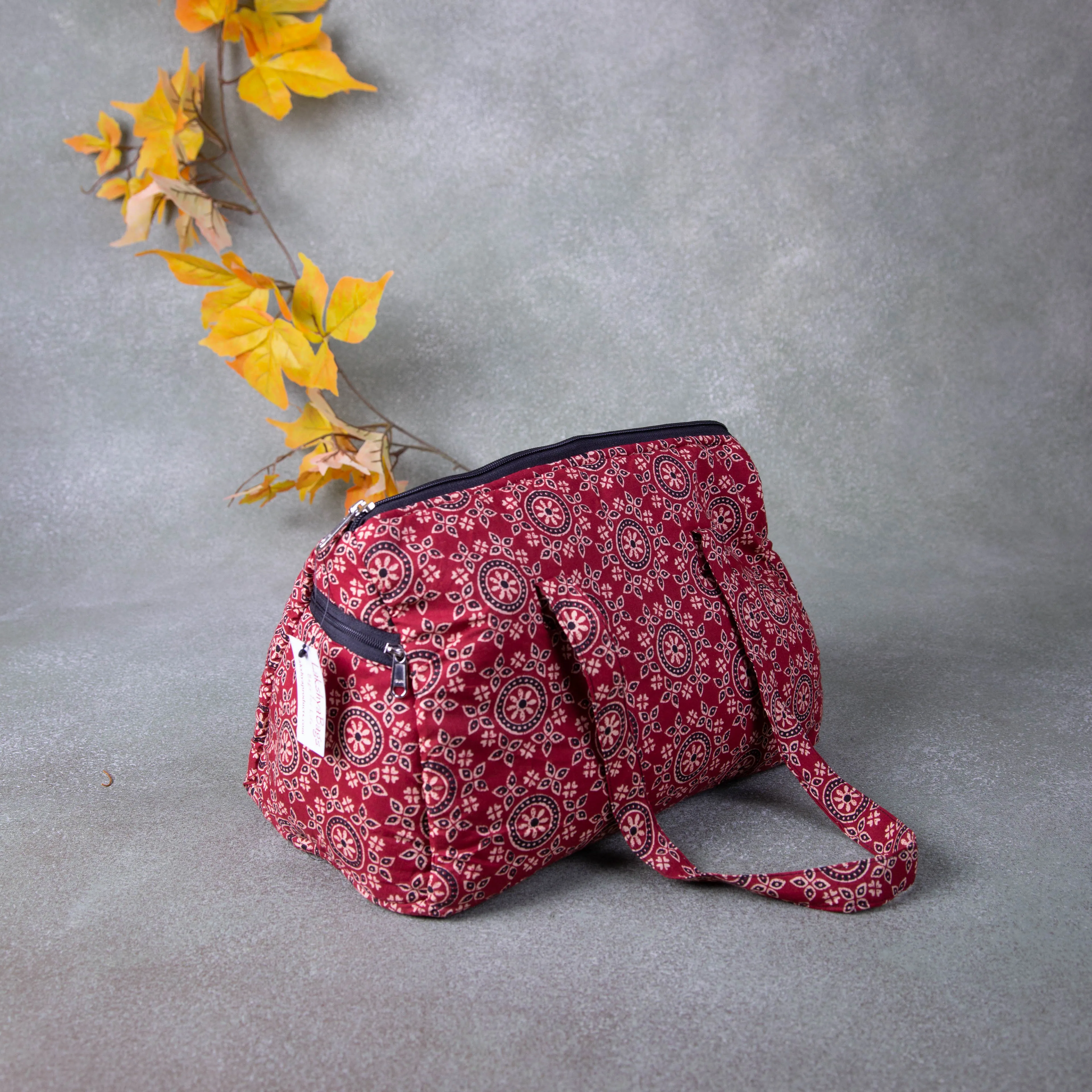 Barrel Handbags Maroon with Golden Flower Design.